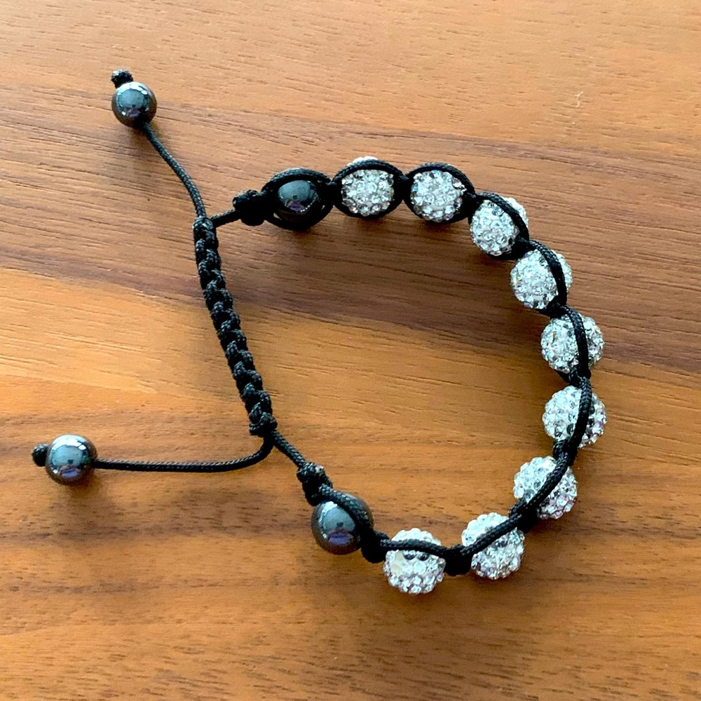 Black and crystal bead bracelet on black cord. Pull ends to shorten it lengthen